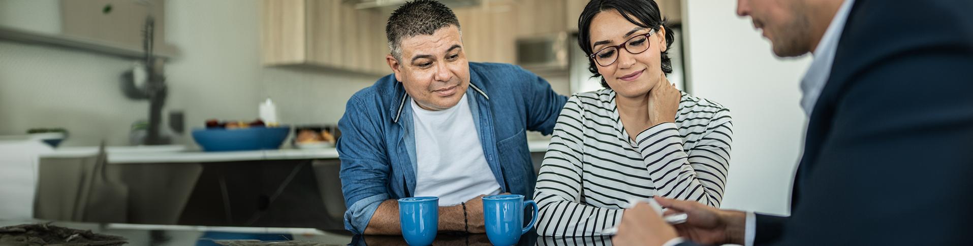 Couple discussing with their financial planner in order to get a car loan or mortgage with their bad credit