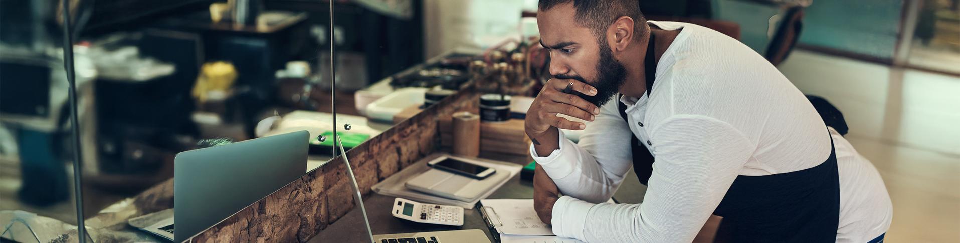 Entrepreneur analyzing warning signs in his financial statements.